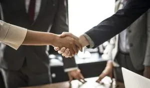 Business handshake in office