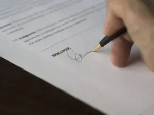 Hand signing contract with pen