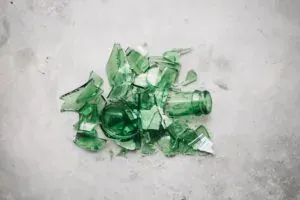 Broken green glass on concrete