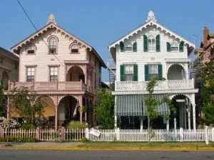 Two Victorian houses with picket fence