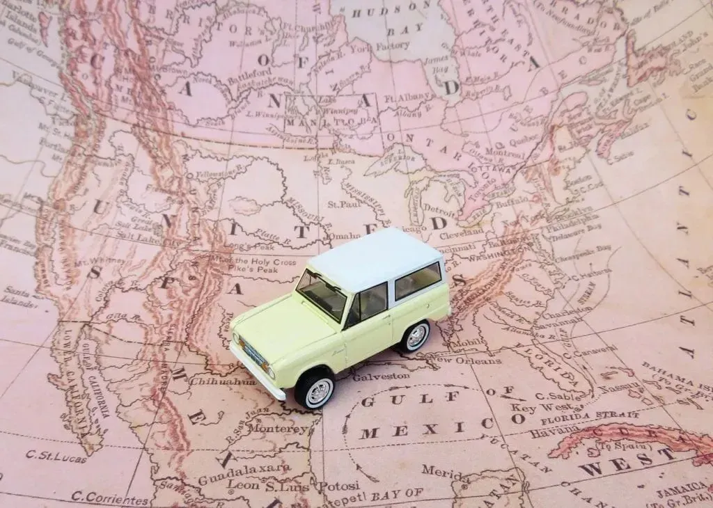 Toy car placed on vintage North America map