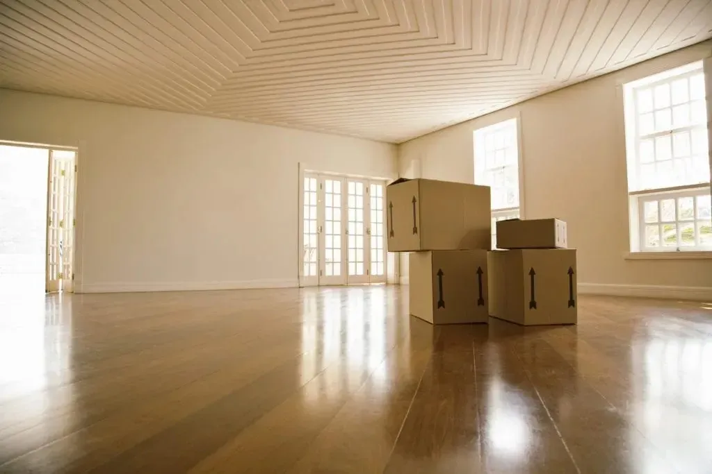 Plain cardboard moving boxes in empty hardwood room