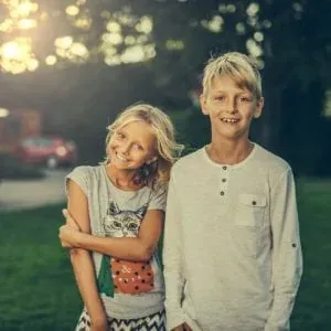 Two smiling kids outdoors