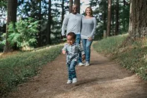 Family walking on forest path