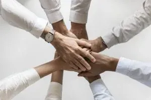 Stacked hands teamwork closeup