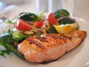 Salmon fillet with salad plate