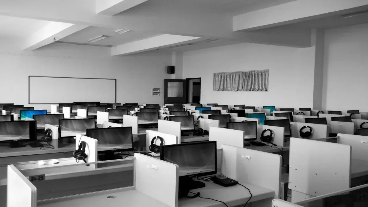 Empty computer lab cubicles with monitors and headsets