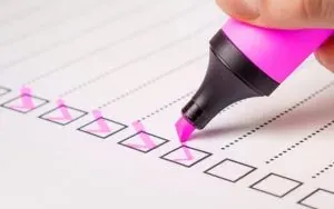 Pink marker checking checklist boxes
