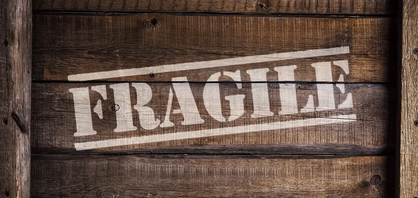 Fragile stencil stamped on wooden crate boards