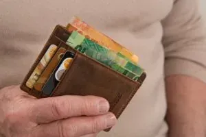 Hand holding wallet with cards