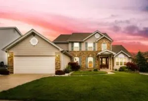 Suburban house at sunset sky