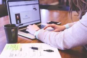 Woman browsing on laptop at desk
