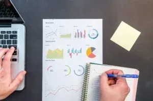 Hands with charts printout and notebook