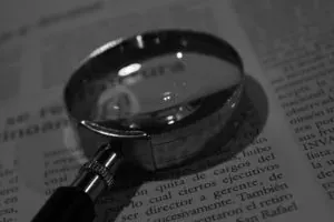 Magnifying glass on newspaper text