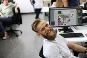 Smiling bearded man in office