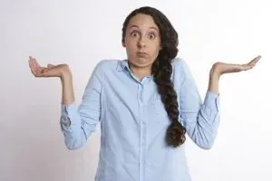 Woman shrugging, confused expression