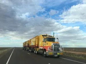 Yellow road train truck, no readable lettering