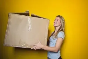Woman holding plain cardboard box