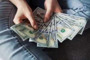Hands fanning dollar bills