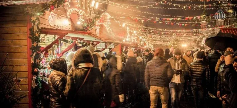 Crowded night Christmas market with lights