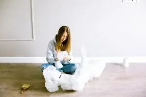 Woman on floor unpacking wrapped items