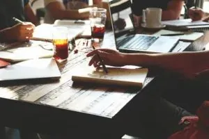 Team meeting around wooden table