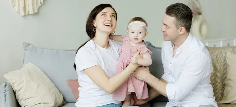 Parents with baby on couch