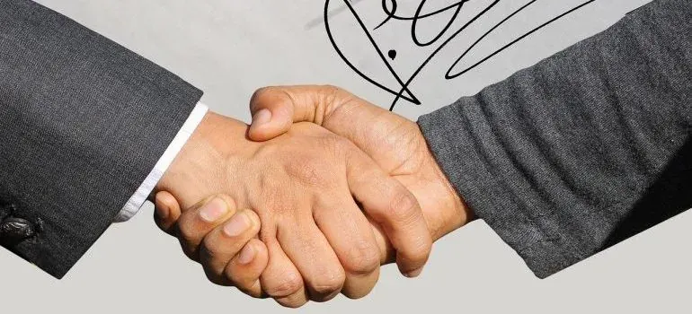 Handshake closeup over signed document