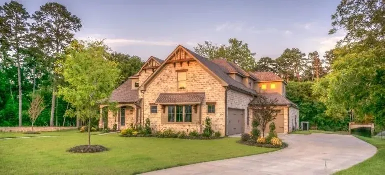 Large brick suburban house with lawn and driveway