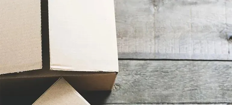 Close-up of plain cardboard boxes on wooden floor