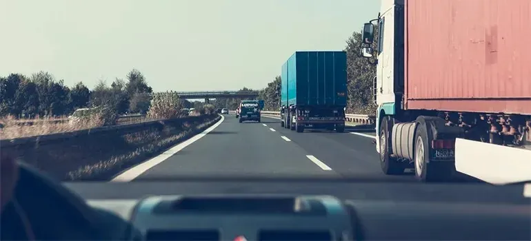 Highway traffic with semi trucks, no legible company branding