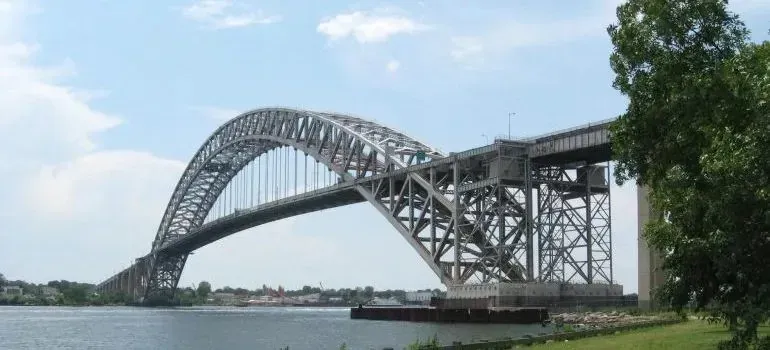 Bayonne Bridge steel arch spanning waterway on sunny day