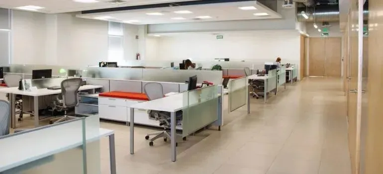 Open-plan office with cubicle desks and chairs