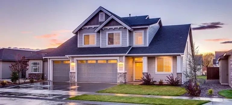 Suburban house with three-car garage at dusk