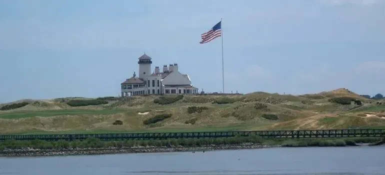 Waterfront clubhouse with lighthouse tower and American flag