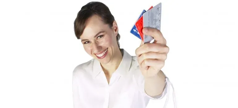 Smiling woman holding credit cards