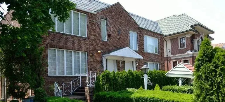 Brick houses with trimmed hedges in residential neighborhood