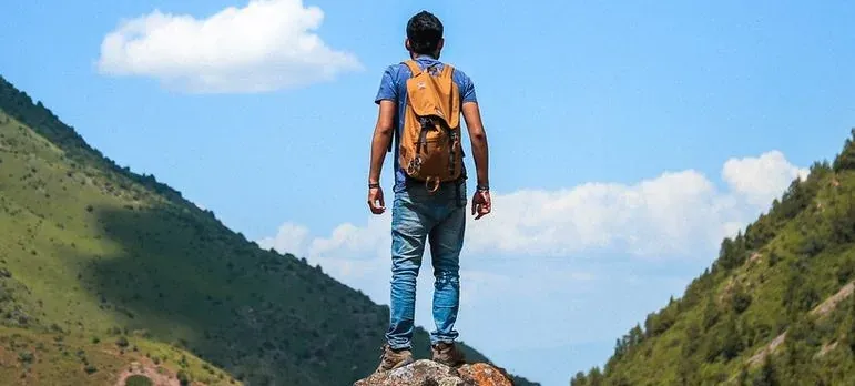 Hiker with backpack on mountain peak