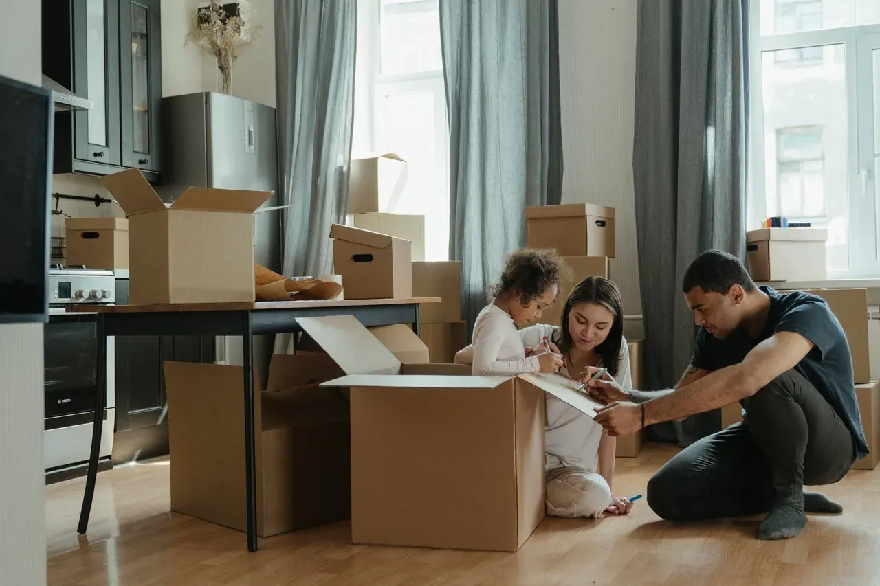 A moving crew carrying boxes into a New Jersey family home