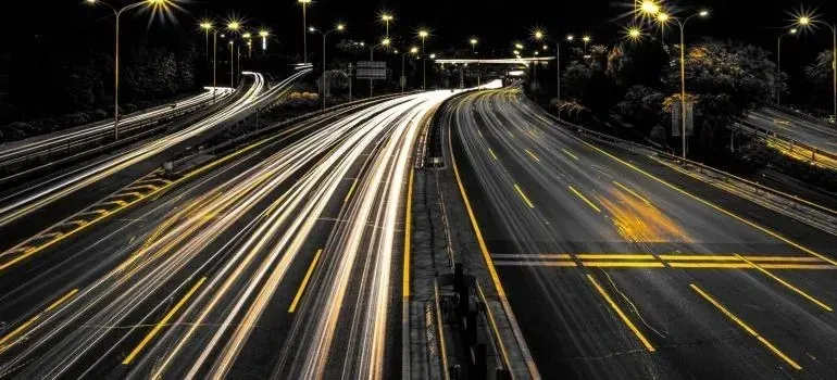 Night highway with long-exposure traffic light trails