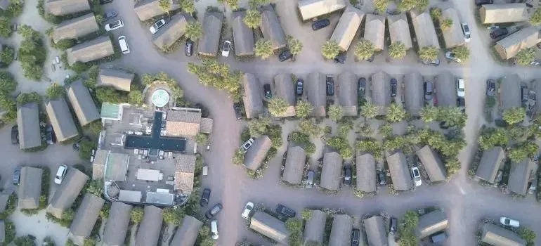 Aerial view of bungalow resort with parked cars