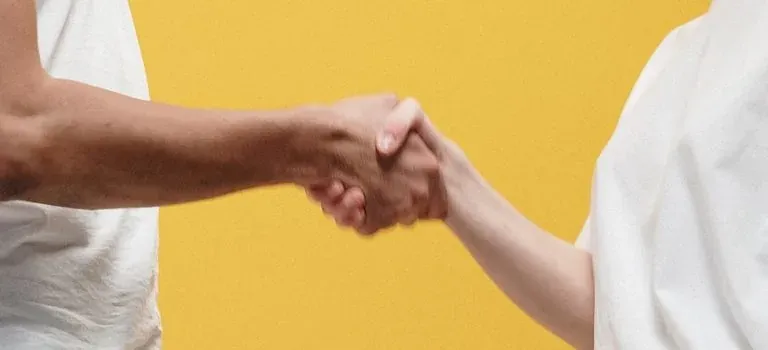 Handshake on yellow background