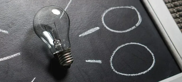 Light bulb on chalkboard sketch