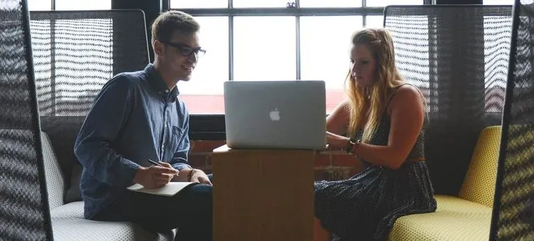 Man and woman working at laptop