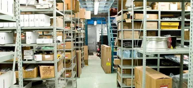 Warehouse shelving aisles filled with boxes and supplies