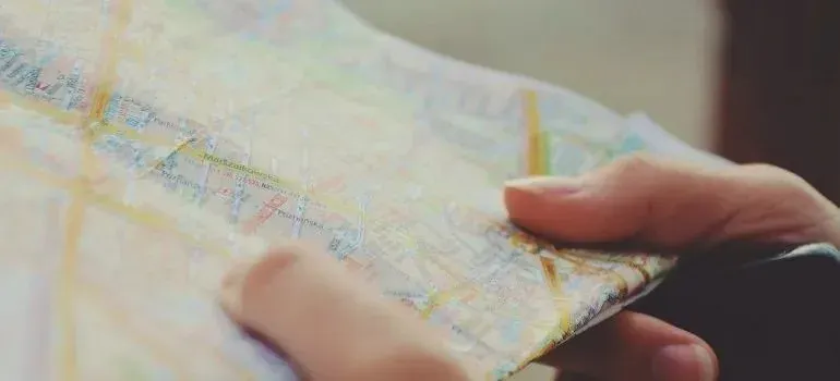 Hands holding a folded paper city map