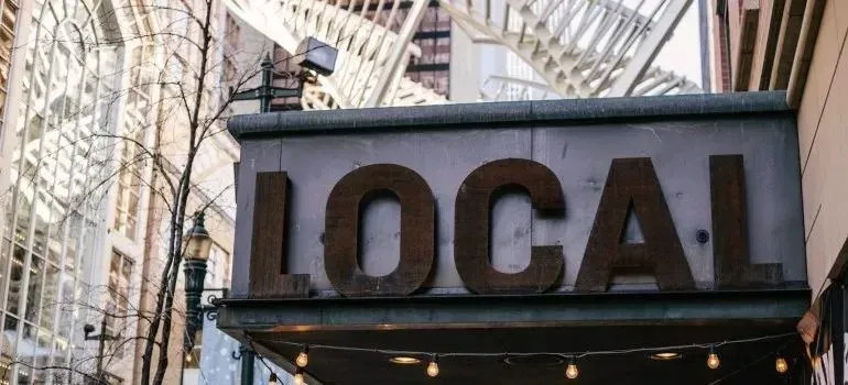 Rustic LOCAL sign with string lights, generic wording