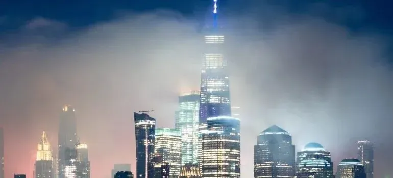 Foggy New York City skyline illuminated at night