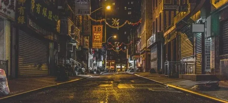 Deserted Chinatown street at night with glowing shop signs