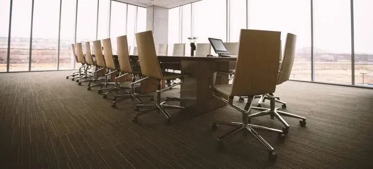 Empty conference room with long table and office chairs